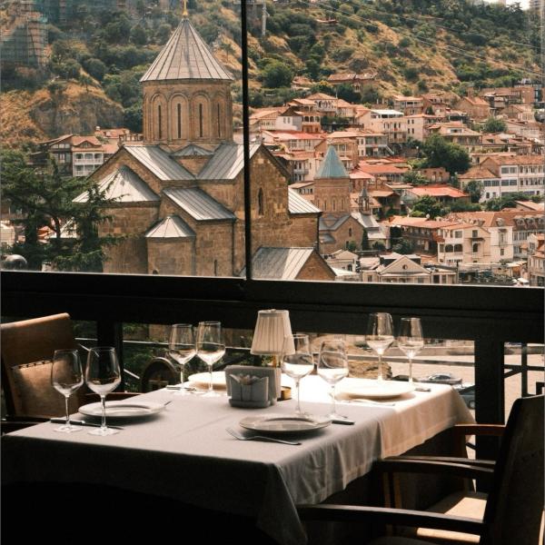 In Georgia, the table is rarely just somewhere to eat.

In Kakheti, the country’s principal wine region, vineyards spread across the valleys beneath the Caucasus, while winemaking remains closely tied to traditions that stretch back thousands of years. Grapes are still fermented in qvevri, the large clay vessels buried beneath the ground that remain central to Georgian wine culture.

Food is similarly rooted in place and tradition. Khinkali dumplings are folded by hand, bread is baked against the walls of a tone oven, and meals bring together a succession of dishes, and local wine.

For our team, getting to know Georgia meant spending time in its vineyards, cellars and kitchens.