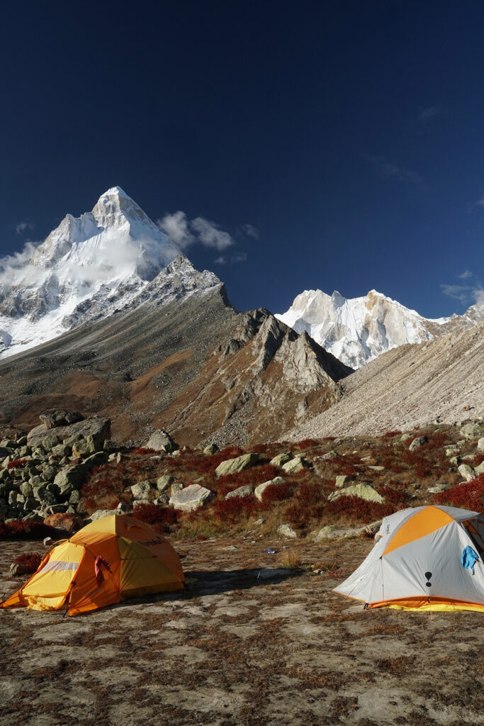 Our camp shows Shivling to the left, and the wide wall of stone in morning light, Meru, to the right sitting lower. Six days after this photo was taken two experienced Polish climbers died on Shivling.